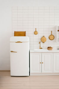 Modern new light wooden kitchen interior with white furniture and kitchen utensils