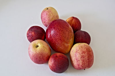 Close-up of apples on table against white background