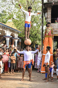 Rear view of people standing on street