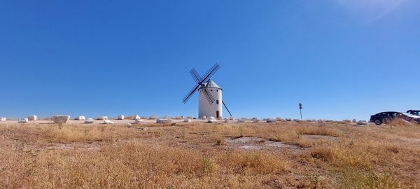 Low angle view of lighthouse against clear blue sky