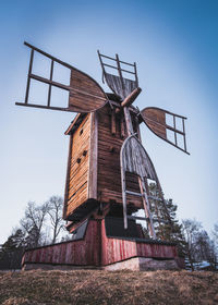 Low angle view of traditional windmill against sky