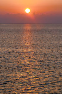 Scenic view of sea against romantic sky at sunset