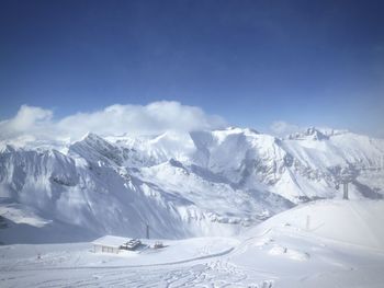 Scenic view of snow covered mountains against sky