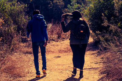 Rear view of couple standing in forest