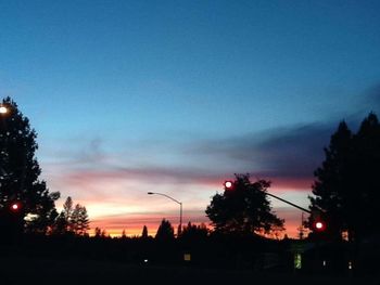 Silhouette of trees against sky at dusk