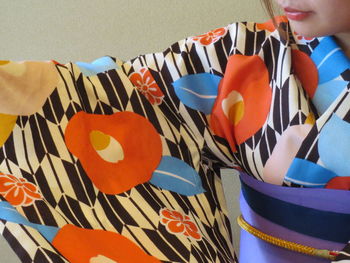 Cropped image of woman wearing floral patterned traditional clothing