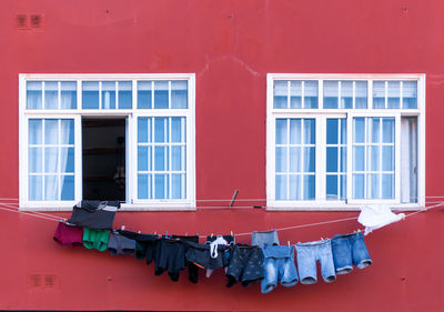 Close-up of clothes drying on window of building