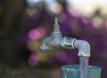 Close-up of faucet against black background