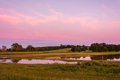 Scenic view of field against sky during sunset