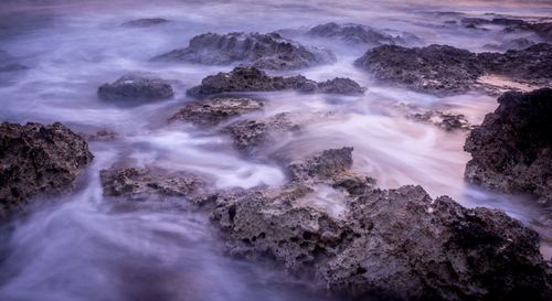 High angle view of waves on rocks