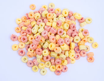 High angle view of multi colored candies against white background