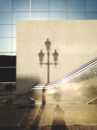 Shadow of street light on escalator