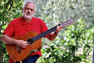 Portrait of man playing guitar