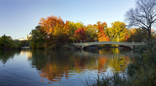 Bridge over lake against sky during autumn