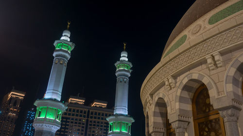 Low angle view of illuminated buildings against sky at night