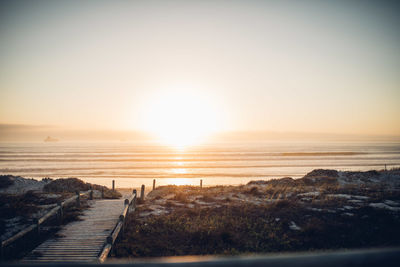 Scenic view of sea against clear sky during sunset