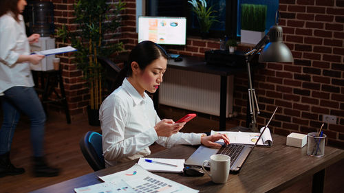 Side view of business colleagues working in office