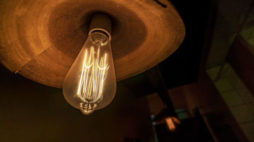 Low angle view of illuminated light bulb at home