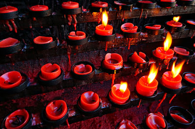 High angle view of red lit candles