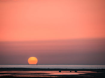 Scenic view of sea against romantic sky at sunset