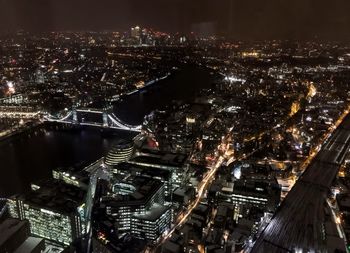 High angle view of illuminated buildings in city at night