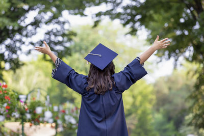 Midsection of woman with arms raised