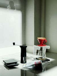 Close-up of coffee cup on table against wall