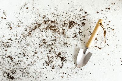High angle view of cigarette on sand