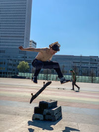 Man skateboarding on skateboard against sky