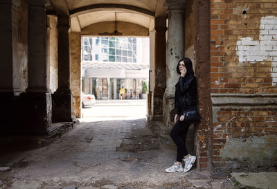 Full length of woman standing in abandoned building