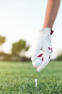 Low section of woman standing on field