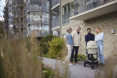 People in front of block of flats