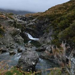 Scenic view of river flowing through rocks