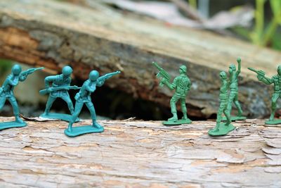 Close-up of figurines on wood