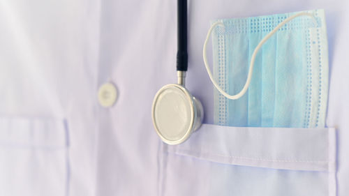 Close-up of eyeglasses on white wall