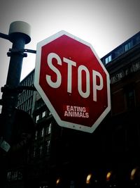 Low angle view of road sign against sky