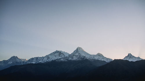 Scenic view of snowcapped mountains against clear sky