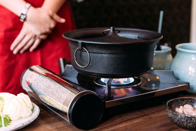 Midsection of woman preparing food in kitchen