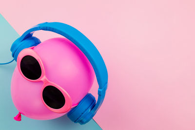 High angle view of multi colored umbrella against pink background