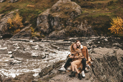 Woman sitting on rock