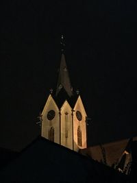 Low angle view of bell tower against sky at night