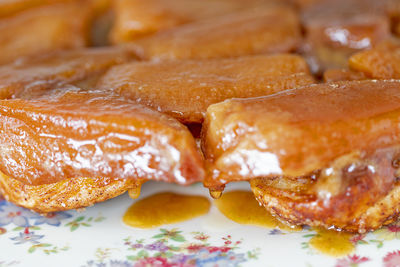 Apple tarte tatin close up with drop of caramel dripping.