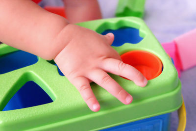 Close-up of baby playing with hand