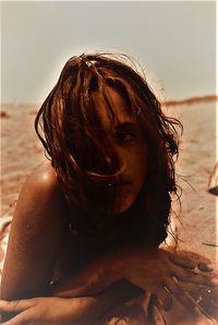 Rear view of woman at beach during sunset