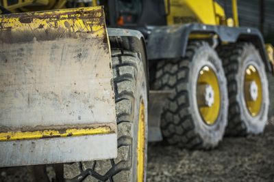 Close-up of earth mover on road