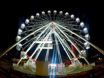 Low angle view of illuminated ferris wheel at night