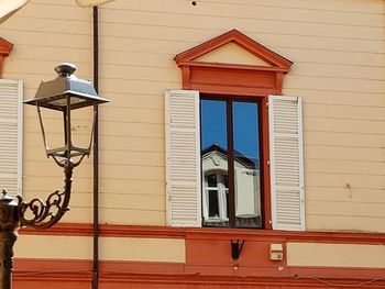 Low angle view of street light against building