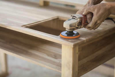 Cropped hand of man working in workshop