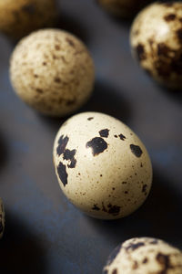 Quail eggs on a black table.