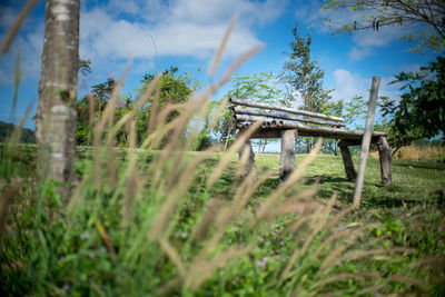 Low angle view of metallic structure on field against sky